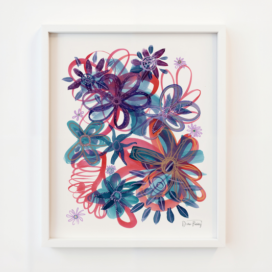A framed abstract floral art print featuring layered stylized flowers in shades of purple, blue, teal, and coral red on a white background, enclosed in a white frame and mounted on a white wall.