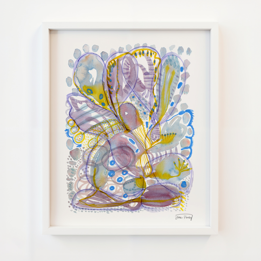 A framed abstract art print featuring purple, blue, yellow, and gray organic shapes on white paper, housed in a white frame and mounted on a white wall.